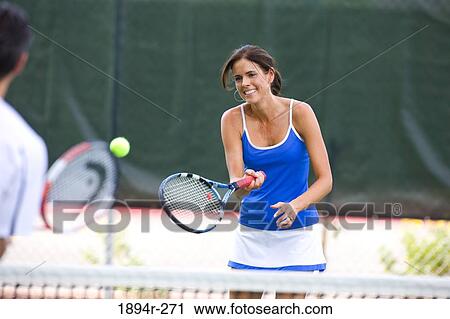 Young couple playing tennis in the court of a tourist resort View Large Photo Image Stock Image - Young couple playing tennis in the court of a tourist resort. Fotosearch