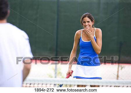 Young couple playing tennis in the court of a tourist resort View Large Photo Image Stock Image - Young couple playing tennis in the court of a tourist resort. Fotosearch
