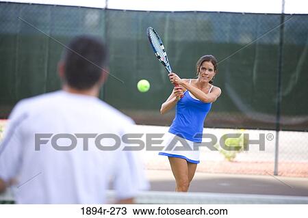 Young couple playing tennis in the court of a tourist resort View Large Photo Image Stock Image - Young couple playing tennis in the court of a tourist resort. Fotosearch