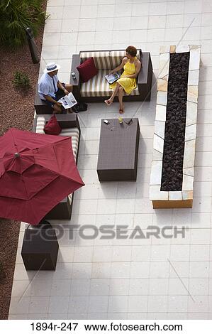 Young couple reading newspapers in a tourist resort View Large Photo Image Stock Photo - Young couple reading newspapers in a tourist resort. Fotosearch