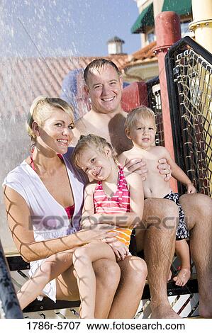 Young family on vacation at water park View Large Photo Image Stock Photo - Young family on vacation at water park. Fotosearch