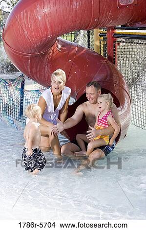 Picture - Young family playing at water park. Fotosearch