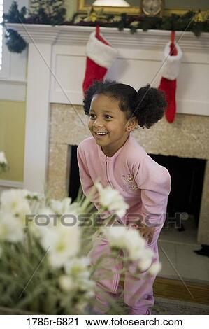 Young girl in pajamas standing by fireplace decorated for Christmas, waiting for Santa View Large Photo Image Stock Image - Young girl in pajamas standing by fireplace decorated for Christmas, waiting for Santa. Fotosearch