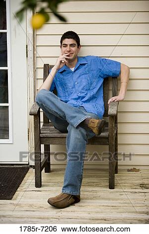 Young Mexican-American man sitting on porch View Large Photo Image Stock Photograph - Young Mexican-American man sitting on porch. Fotosearch