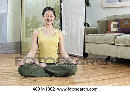 Young woman doing yoga at home View Large Photo Image Stock Image - Young woman doing yoga at home. Fotosearch