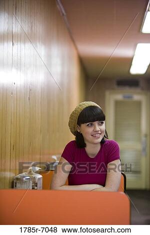 Young woman having lunch in a diner View Large Photo Image Stock Photo - Young woman having lunch in a diner. Fotosearch