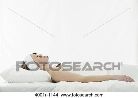 Young woman having stone treatment at spa View Large Photo Image Picture - Young woman having stone treatment at spa. Fotosearch