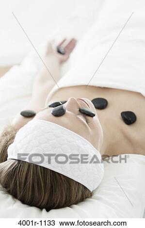Young woman having stone treatment at spa View Large Photo Image Stock Image - Young woman having stone treatment at spa. Fotosearch