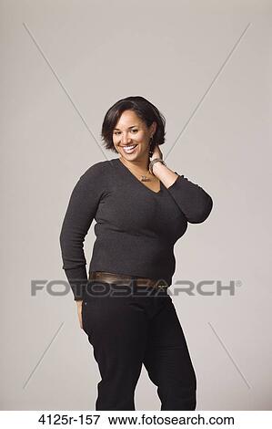 Stock Photo - Young woman laughing with her hand on hip. Fotosearch