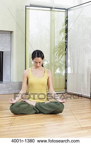 Young woman meditating at home View Large Photo Image Stock Image - Young woman meditating at home. Fotosearch