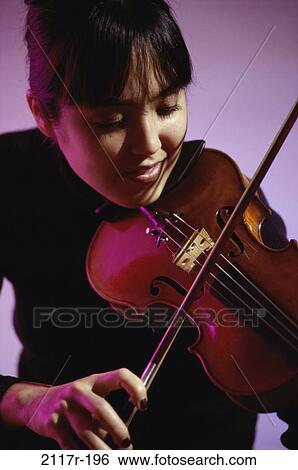 Young woman playing the violin View Large Photo Image Stock Photograph - Young woman playing the violin. Fotosearch