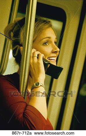 Stock Image - Young woman talking on a mobile phone. Fotosearch