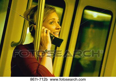 Young woman talking on a mobile phone View Large Photo Image Stock Image - Young woman talking on a mobile phone. Fotosearch