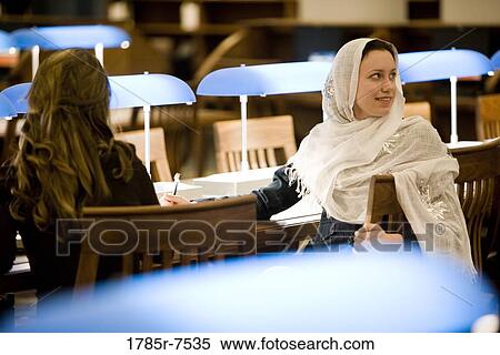 Young women studying in the reading room of a library View Large Photo Image Stock Photography - Young women studying in the reading room of a library. Fotosearch