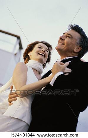 Picture - Couple holding each other on a ship. Fotosearch