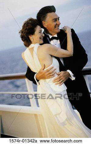Stock Image - Couple holding each other on a ship. Fotosearch