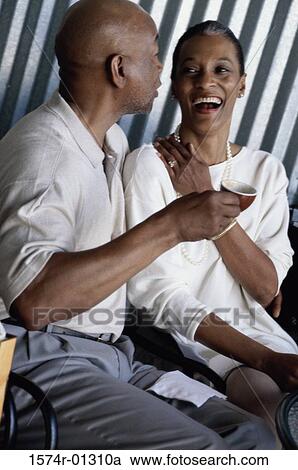 Couple sitting together drinking coffee View Large Photo Image Stock Image - Couple sitting together drinking coffee. Fotosearch
