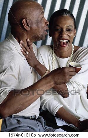 Couple sitting together drinking coffee View Large Photo Image Stock Image - Couple sitting together drinking coffee. Fotosearch