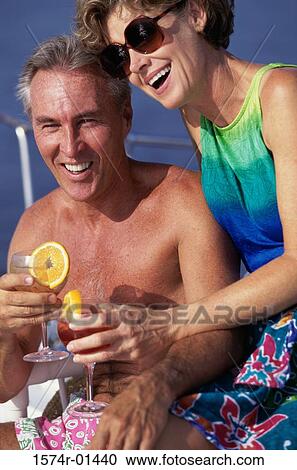 Couple sitting together with drinks View Large Photo Image Stock Image - Couple sitting together with drinks. Fotosearch