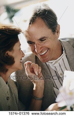 Couple smiling at each other View Large Photo Image Stock Photograph - Couple smiling at each other. Fotosearch