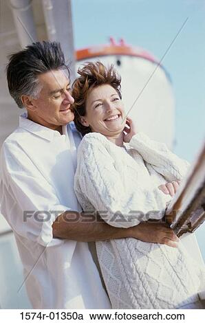Couple standing against a railing on a ship View Large Photo Image Stock Image - Couple standing against a railing on a ship. Fotosearch