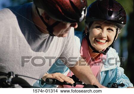 Couple wearing cycling helmet View Large Photo Image Picture - Couple wearing cycling helmet. Fotosearch