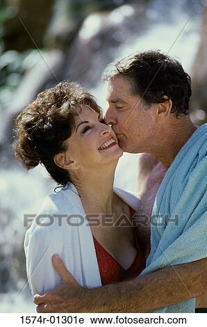 Man kissing a woman on the cheek View Large Photo Image Stock Image - Man kissing a woman on the cheek. Fotosearch