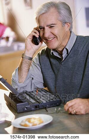 Stock Photo - Man talking on a mobile phone. Fotosearch