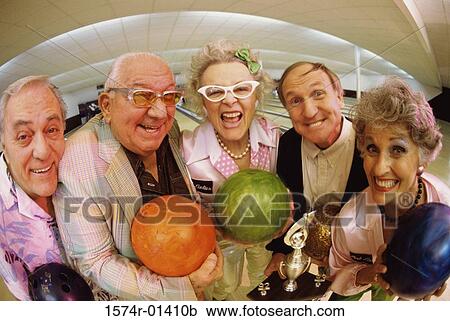 Stock Image - Portrait of a bowling team in a bowling alley. Fotosearch