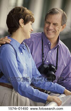 Stock Image - Portrait of a couple looking at each other smiling. Fotosearch