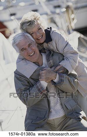 Stock Image - Portrait of a senior couple holding each other smiling. Fotosearch