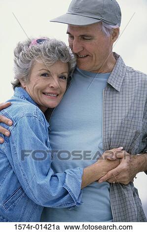 Stock Image - Portrait of a senior couple holding each other. Fotosearch