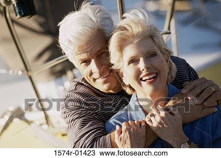 Stock Image - Portrait of a senior couple holding each other. Fotosearch