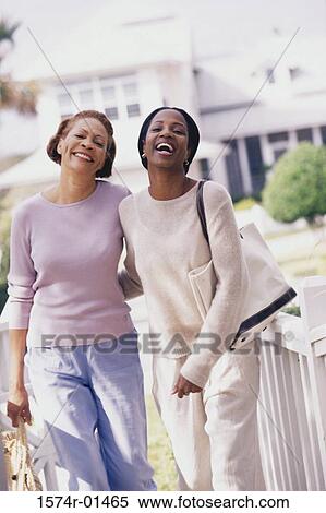 Stock Photography - Portrait of two women standing outdoors. Fotosearch