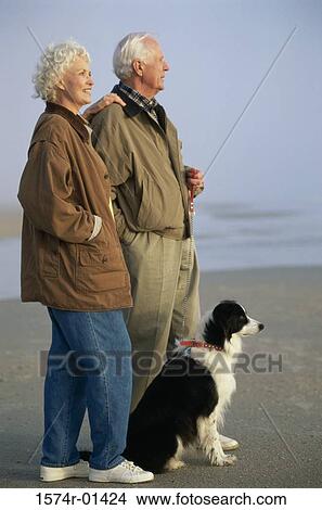 Senior couple at the beach with their dog View Large Photo Image Picture - Senior couple at the beach with their dog. Fotosearch
