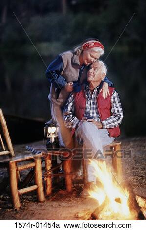 Stock Image - Senior couple camping outdoors. Fotosearch