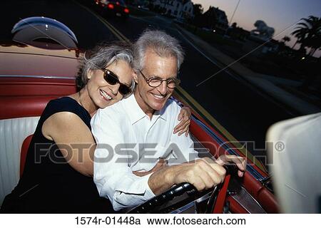 Senior couple driving a convertible car View Large Photo Image Stock Image - Senior couple driving a convertible car. Fotosearch