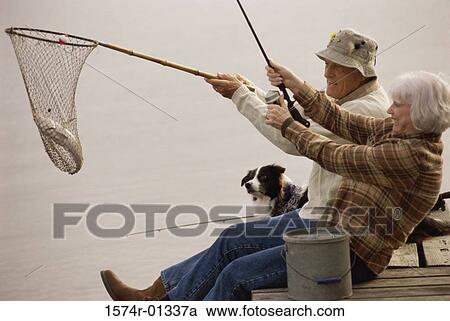 Stock Image - Senior couple fishing. Fotosearch
