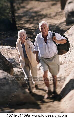Senior couple hiking over a rugged landscape View Large Photo Image Stock Image - Senior couple hiking over a rugged landscape. Fotosearch