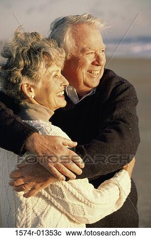 Senior couple holding each other at the beach View Large Photo Image Stock Image - Senior couple holding each other at the beach. Fotosearch