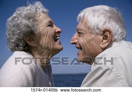 Stock Image - Senior couple laughing face to face. Fotosearch