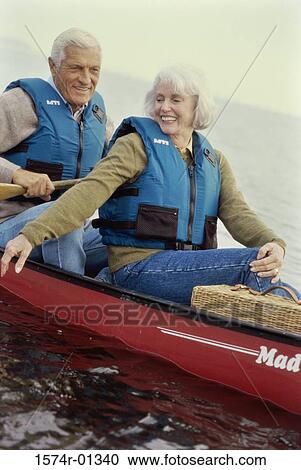 Senior couple sitting in a row boat View Large Photo Image Stock Image - Senior couple sitting in a row boat. Fotosearch