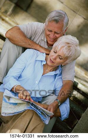 Senior couple sitting on stairs looking at a map View Large Photo Image Stock Image - Senior couple sitting on stairs looking at a map. Fotosearch