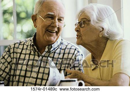 Stock Image - Senior couple talking to each other. Fotosearch