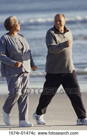 Senior couple walking at the beach View Large Photo Image Stock Image - Senior couple walking at the beach. Fotosearch
