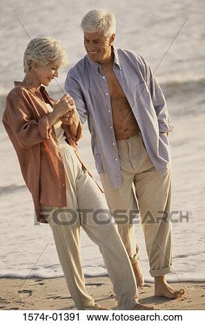 Senior couple walking on the beach View Large Photo Image Stock Image - Senior couple walking on the beach. Fotosearch