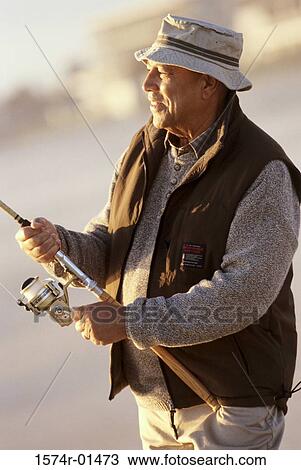 Senior man holding a fishing rod View Large Photo Image Stock Image - Senior man holding a fishing rod. Fotosearch