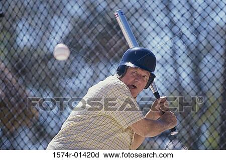 Stock Image - Senior man playing baseball. Fotosearch