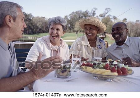 Two senior couples sitting at a table outdoors View Large Photo Image Stock Image - Two senior couples sitting at a table outdoors. Fotosearch