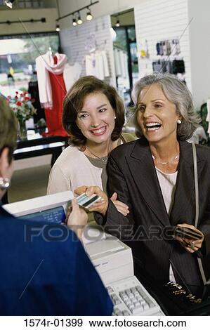 Two women shopping View Large Photo Image Stock Photo - Two women shopping. Fotosearch